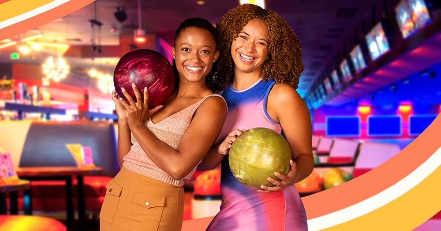 Summer Season Pass two girls holding bowling balls and having fun. 