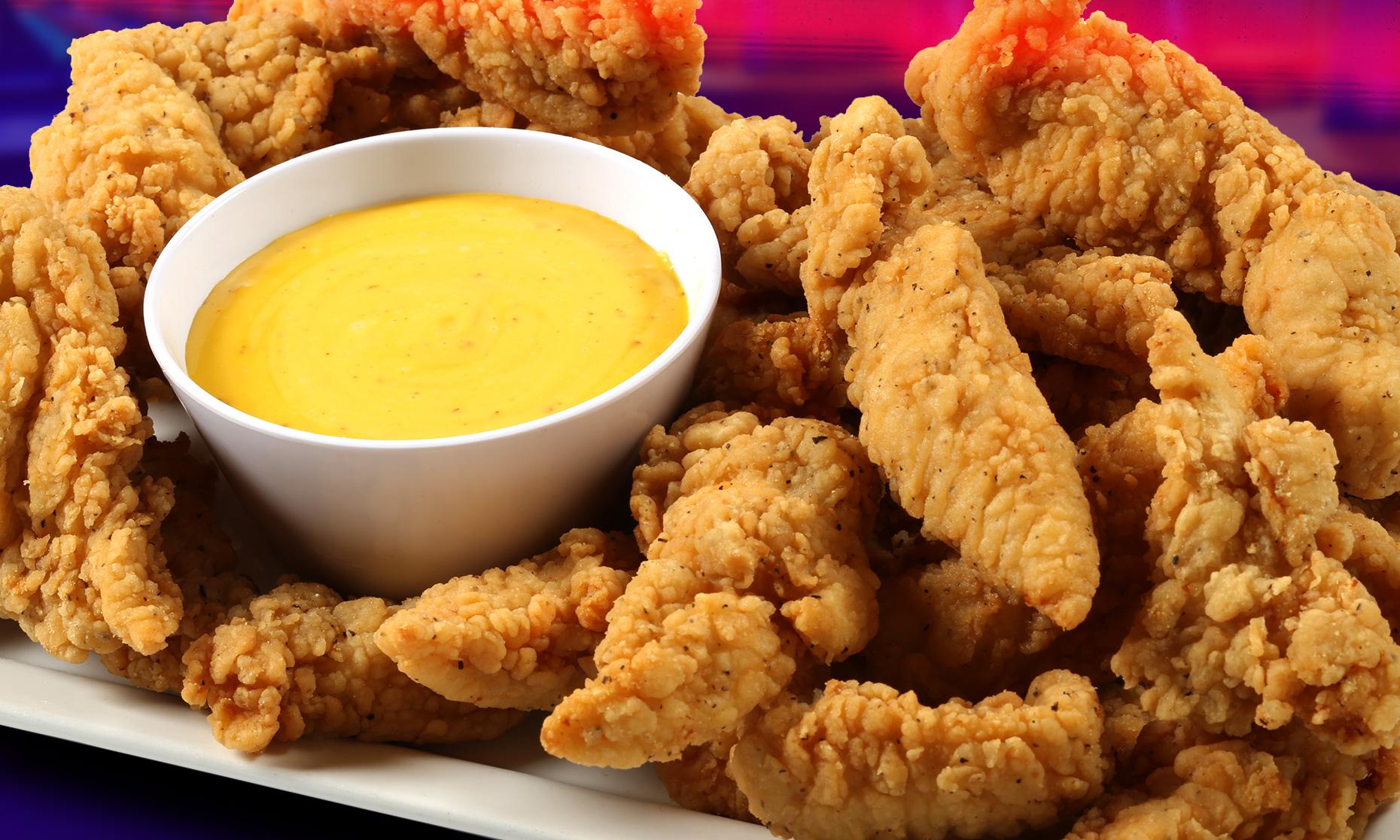 Chicken tenders with a side of honey mustard. 